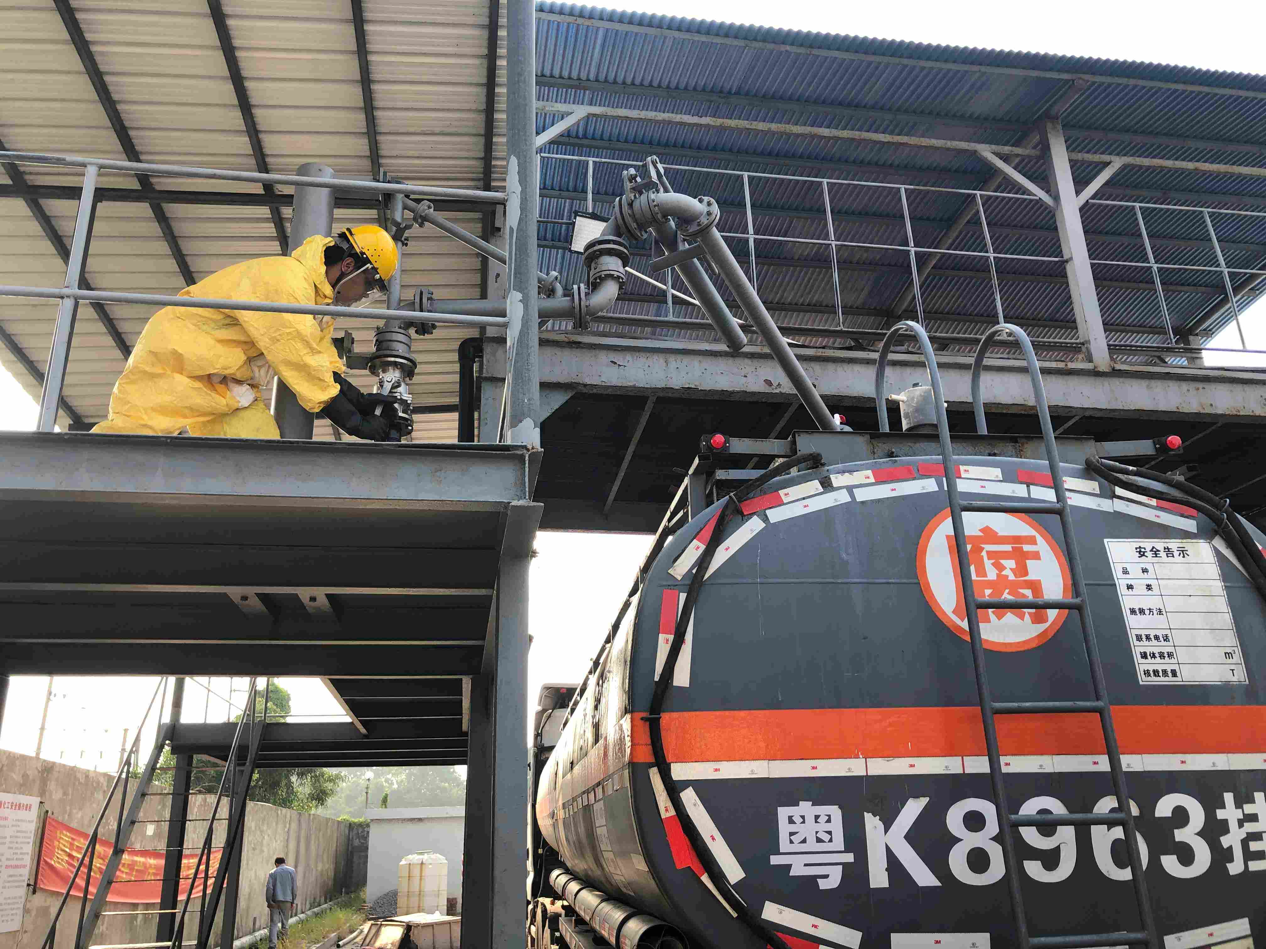 Protected operator loading a hazardous chemical tanker