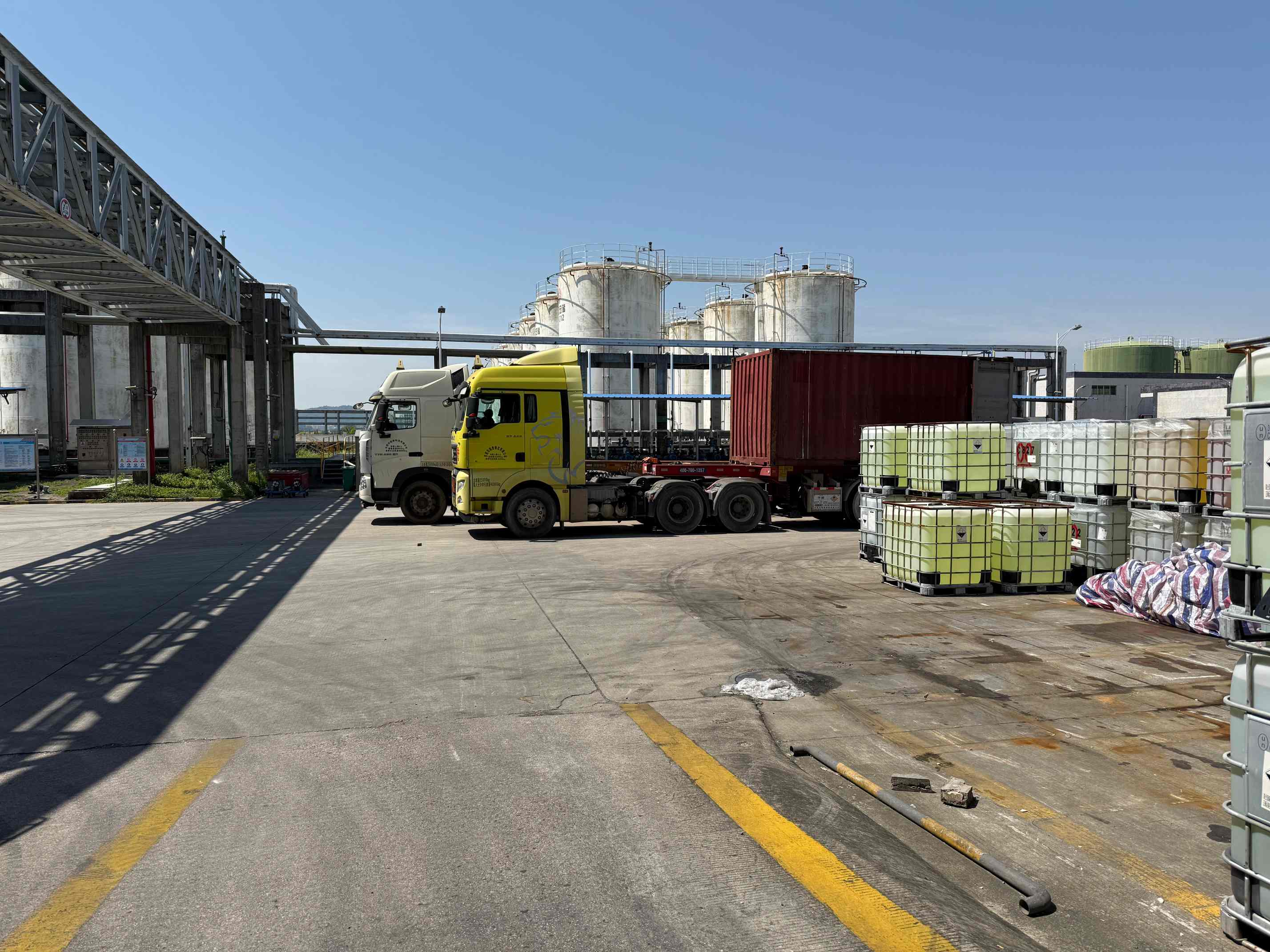Chemical logistics yard with transport vehicles and IBC containers